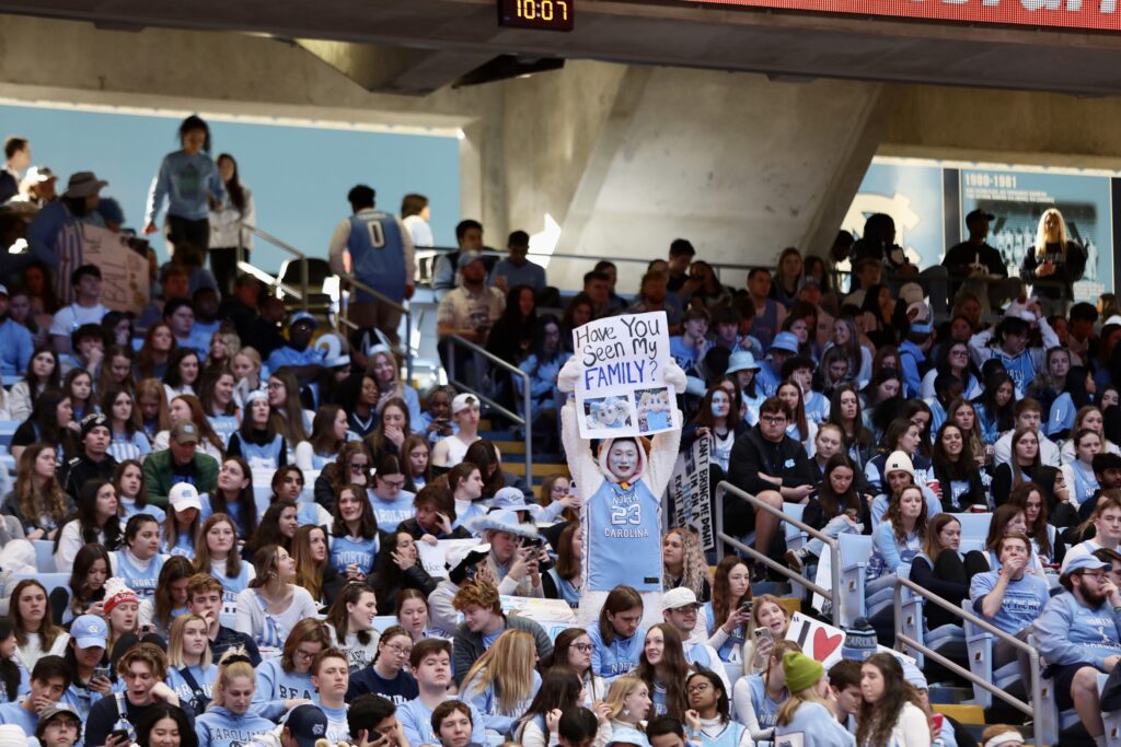 Fan in the stands of the Dean Smith Center holding a handmade sign