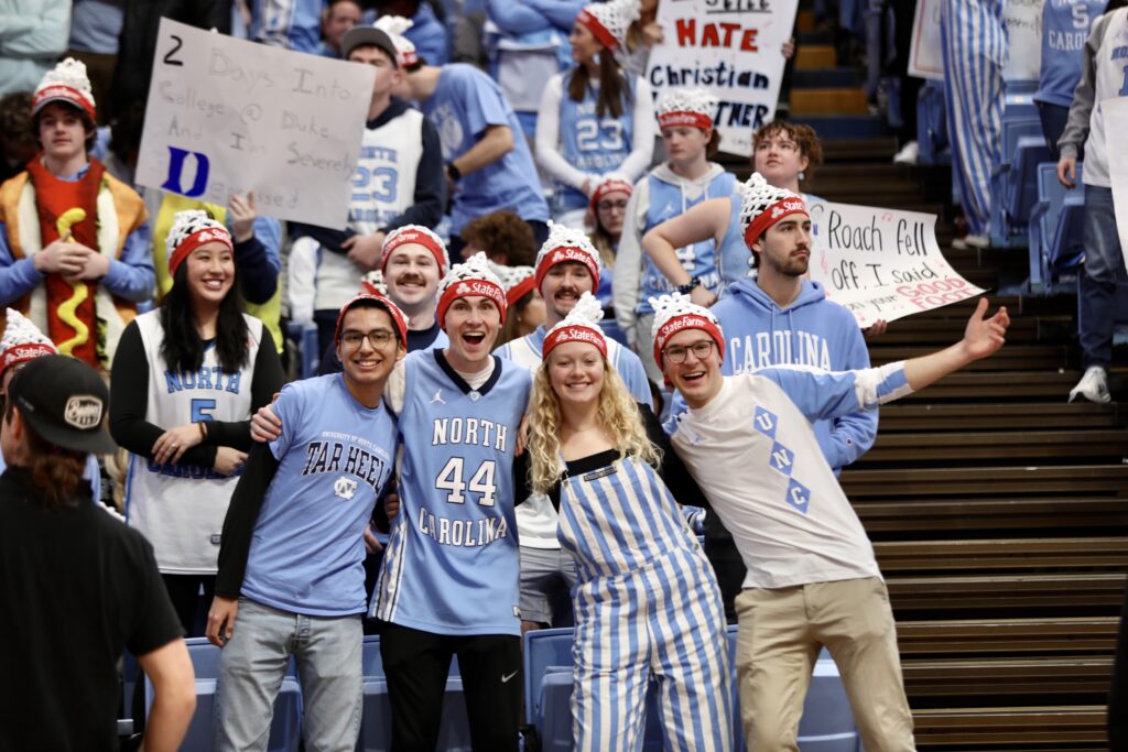 Group of fans in the stands of the Dean Smith Center posing