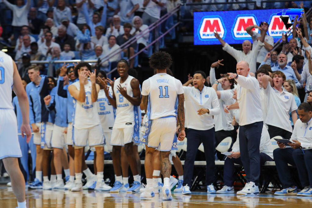 UNC bench celebrates #11 Powell’s three pointer
