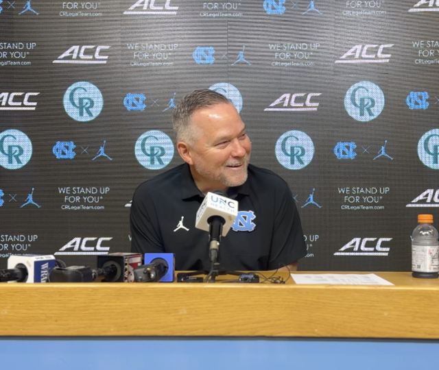 mike malone sitting at podium smiling